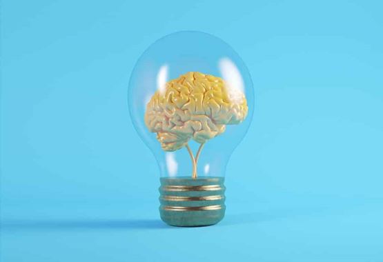 Une lampe contenant un cerveau sur fond bleu
