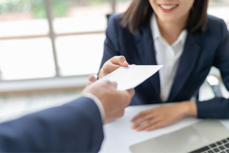 Deux personnes échangeant une enveloppe